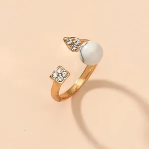 Adjustable gold plated open ring with marble bead and sparkling rhinestone accents