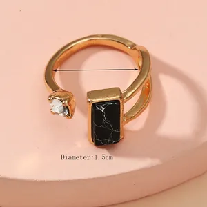 Adjustable gold ring with black marble stone, faux diamond, and 1.5cm diameter detail