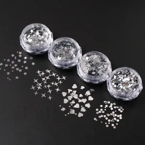 Detail of silver nail art sequins in star heart and dot shapes for manicure DIY