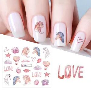 Detail of watercolor unicorn and heart nail stickers featuring soft pink and blue tones