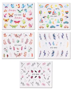 Detailed view of 5 water transfer nail stickers with butterfly and floral art designs