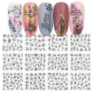 Set of 12 floral and butterfly nail art water decals shown on various nail tips