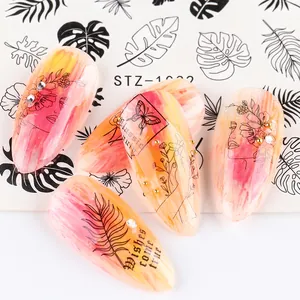 Macro view of minimalist nail stickers with black line art on pink marble finish