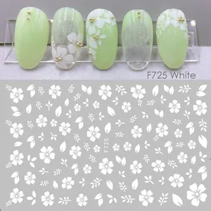 Detail of white floral nail stickers F725 showing real application on mint green nails