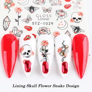 Detailed view of Gothic nail stickers featuring skull, rose and snake patterns with red rhinestones
