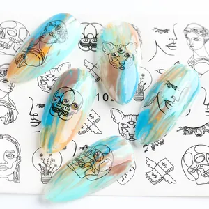 Artistic press-on nails featuring fluid marble textures and black line art face illustrations