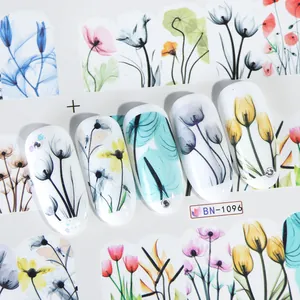 Detail of floral nail art stickers with watercolor tulip and daisy designs on nails