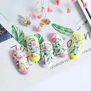 Macro detail of floral nail art stickers featuring dreamy watercolor blooms and petals