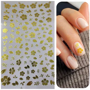 Detailed view of 3D metallic gold floral nail stickers with F725 flower patterns