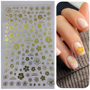 Macro shot of F727 gold 3D cherry blossom nail stickers with floral patterns