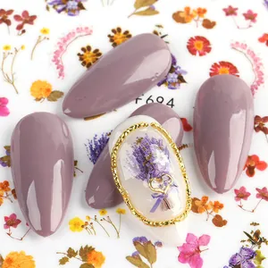 Detail of floral nail sticker with 3D gold heart relief and lavender painting