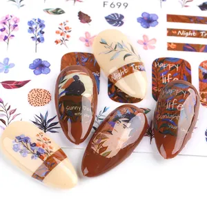 Detail of autumn botanical nail stickers with bees and warm earthy tone floral patterns
