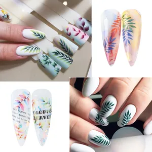 Detail of botanical nail stickers featuring delicate green leaves and French artistic text