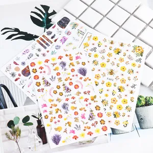 Close-up of floral and bee nail stickers with F693 and F694 patterns for nail art decoration