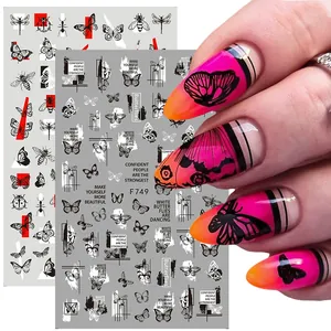 Detailed view of 3D nail art stickers with black butterfly and red line designs