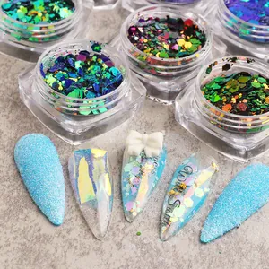 Macro shot of hexagonal nail sequins and glitter art with aurora and 3D bow designs
