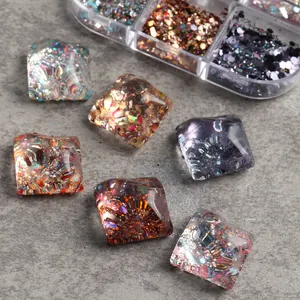 Macro shot of square resin nail sequins with colorful holographic glitter in a storage box