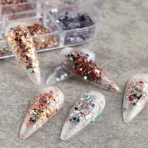 Detailed view of iridescent heart and star nail glitter flakes on manicured nail tips