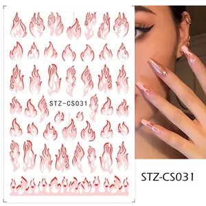 Dettaglio di adesivi 3D per nail art con fiamme sfumate rosse e texture autoadesiva