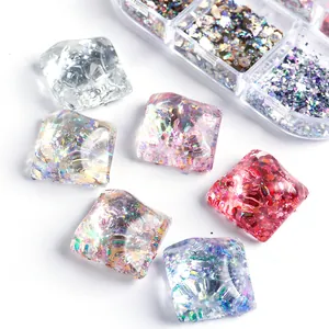 Detailed view of iridescent chunky nail art flakes and colorful glitters in square resin