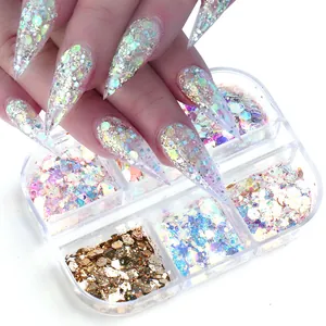 Close-up of holographic nail art sequins with heart shapes in a four-grid container