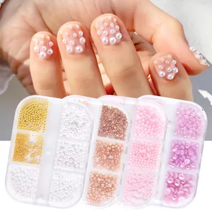 Macro detail of mixed sizes flatback nail art pearls in a multi-grid storage box
