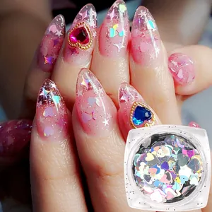 Detailed view of iridescent heart and star sequins applied on long pointed gradient nails