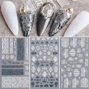 Detail of 5D embossed nail stickers featuring white lace and black rose flower patterns
