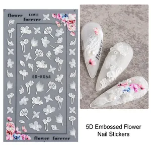 Macro detail of 5D embossed white floral nail art stickers with 3D texture and butterfly motifs