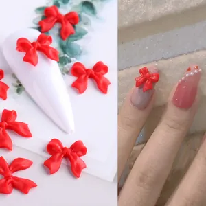 Fiocchi 3D rossi opachi per nail art mostrati su tip bianche e risultati manicure pro