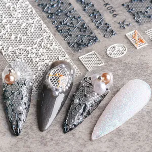 Macro detail of 5D white lace flower nail art stickers with embossed relief texture