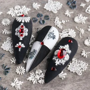 Detail of 5D white lace flower embossed nail sticker with red rhinestones on black matte base