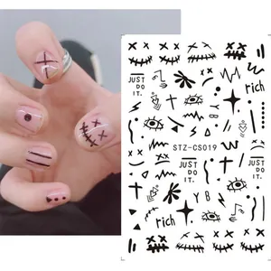 Detail of dark graffiti nail stickers featuring skulls and street style art patterns