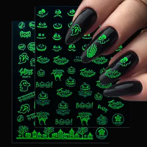 Luminous neon green Halloween nail stickers with ghosts and pumpkins on dark background