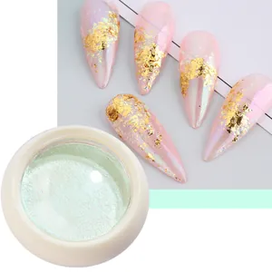 Solid aurora nail powder in light green with iridescent finish and gold foil accents