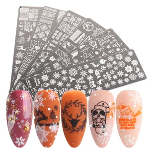 Macro detail of Christmas nail stamping plates with snowflake and reindeer patterns