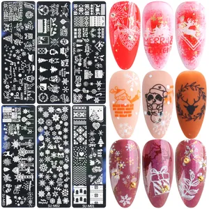 Macro detail showing Christmas nail stamping plates with snowflake and reindeer patterns