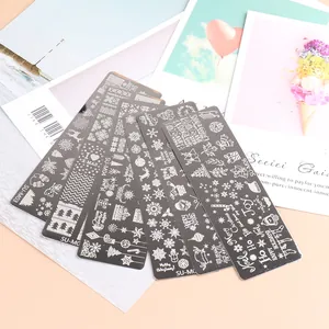 Detailed view of stainless steel nail stamping plates with Christmas snowflake and tree patterns