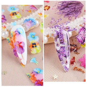 Detailed view of autumn floral nail foil wraps featuring lavender and pansy patterns