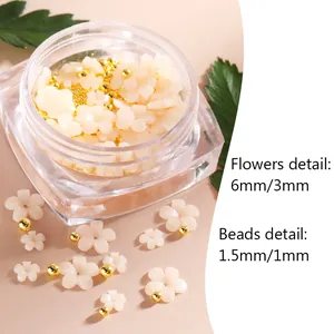 Mix of 3mm and 6mm white 3D resin flowers with gold metal beads in a square bottle
