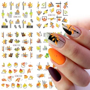 Detailed view of autumn maple leaf nail stickers with pumpkin and line art designs