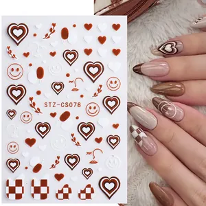 Detail view of 3D adhesive nail stickers with checkered heart and smiley face patterns