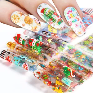 Detalle de láminas de nail art navideño con diseños de Papá Noel y copos de nieve para DIY