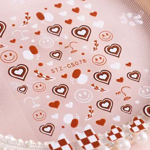 Adhesive nail art stickers featuring red hearts, smiley faces and checkerboard patterns