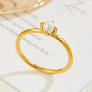 Elegant gold titanium steel ring with white pearl in a vintage four-prong setting