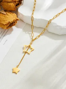Detailed close-up of a golden Y-shaped tassel necklace with pentagram star pendants