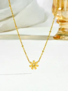 Close-up of golden daisy pendant with central zircon on delicate beaded titanium steel chain