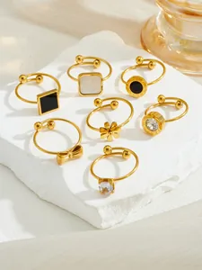 Macro shot of 7-piece gold-plated rings set featuring Roman numerals and zircon details