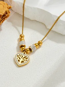 Detail of gold heart pendant necklace featuring Tree of Life design and sparkling crystals