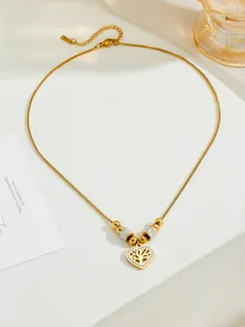 Detail shot of golden tree of life heart pendant necklace with shimmering cubic zirconia